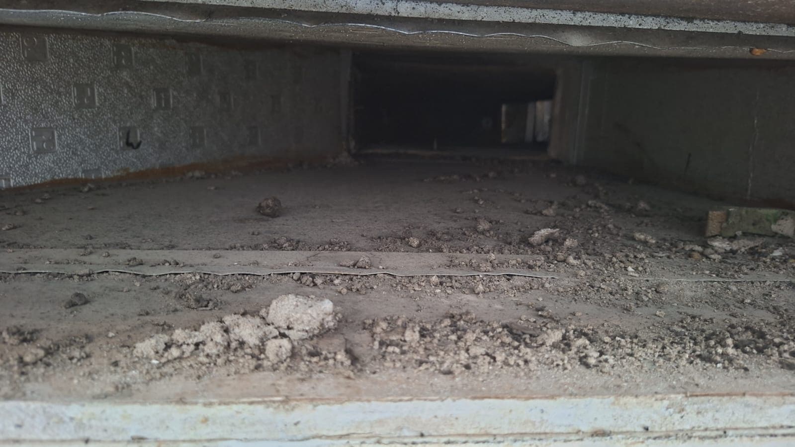 AC air duct interior before and after professional cleaning, heavy dust removed with a rotary brush and negative-air vacuum