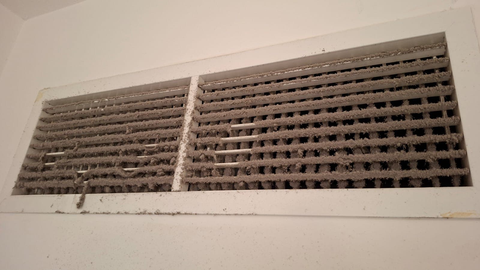 AC vent grille before and after cleaning, dust and grime removed