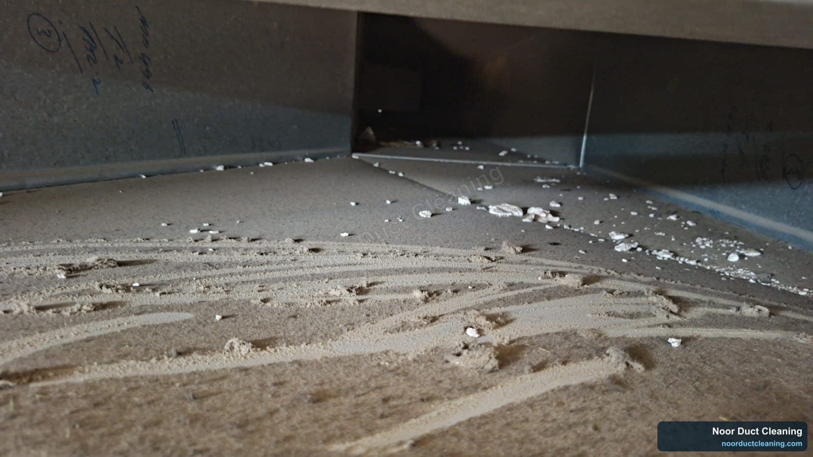 AC duct floor in a Dubai home before and after cleaning, a full-width layer of fine desert dust extracted